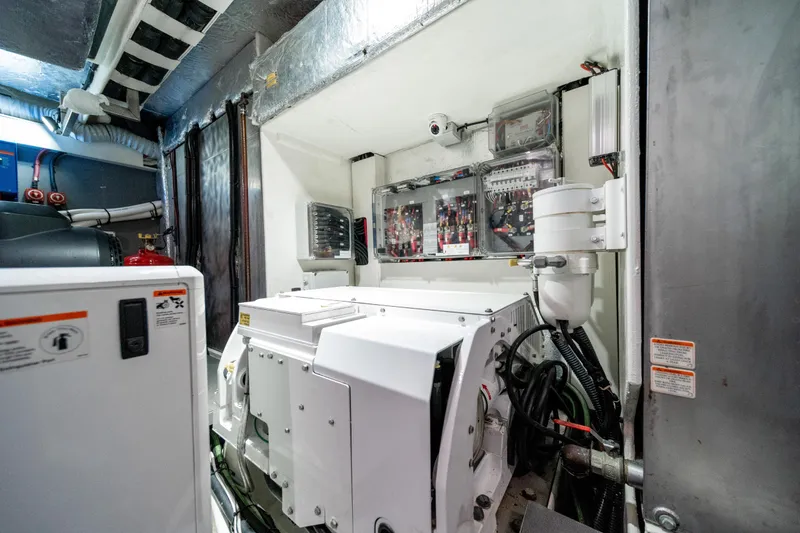 Slide: The Image of Engine room of 2018 Absolute 58 Navetta yacht, showcasing machinery and control panels. - 78