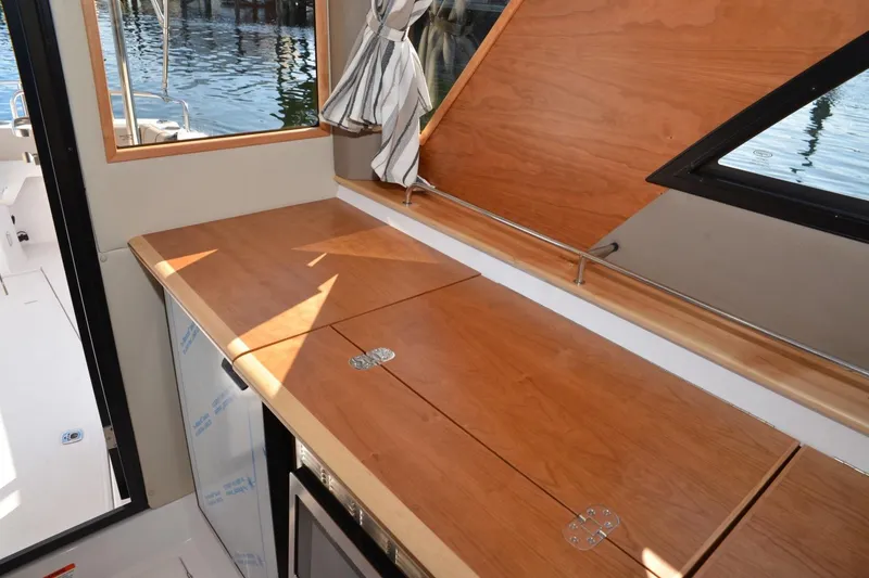 Slide: The Image of Interior of 2020 Cutwater C-30S boat with wooden cabinetry and window view. - 12