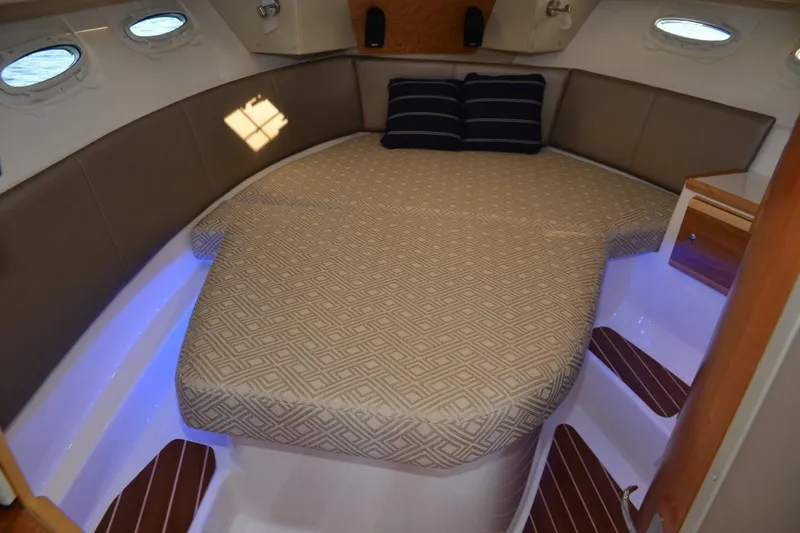 Slide: The Image of 2020 Cutwater C-30S boat interior with cozy bed and ambient lighting. - 16