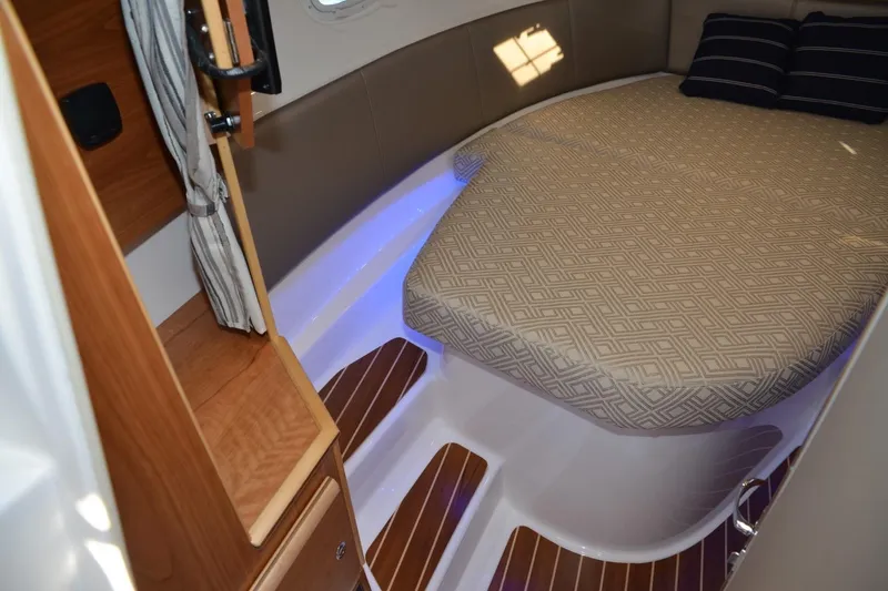Slide: The Image of 2020 Cutwater C-30S cabin interior with bed, wood accents, and ambient lighting. - 17