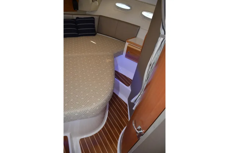 Slide: The Image of 2020 Cutwater C-30S cabin interior with bed, wooden flooring, and ambient lighting. - 18