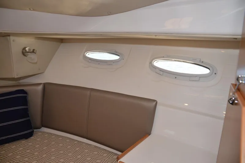 Slide: The Image of 2020 Cutwater C-30S interior cabin with portholes, cushioned seating, and modern design. - 20