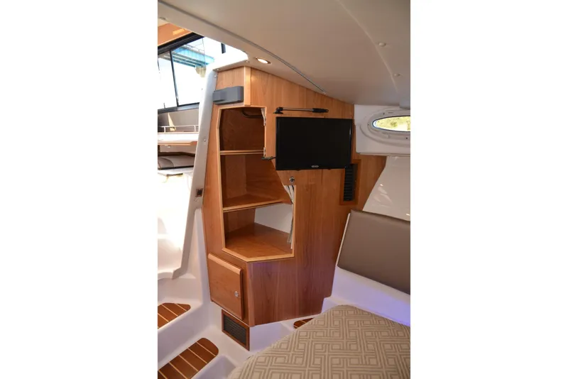 Slide: The Image of 2020 Cutwater C-30S interior with wooden cabinetry and mounted TV. - 21