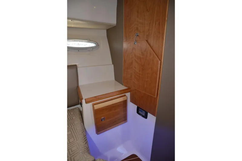Slide: The Image of 2020 Cutwater C-30S interior with wooden cabinetry and porthole window. - 23