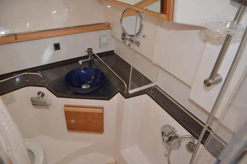 Slide: The Image of 2020 Cutwater C-30S boat bathroom with modern fixtures and blue vessel sink. - 26