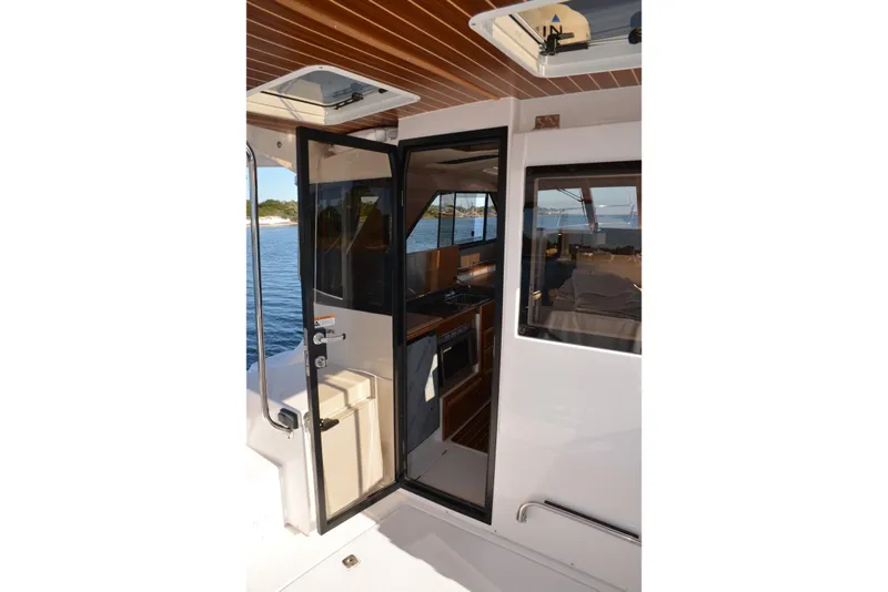 Slide: The Image of 2020 Cutwater C-30S boat interior with open door, showcasing cabin and water view. - 30