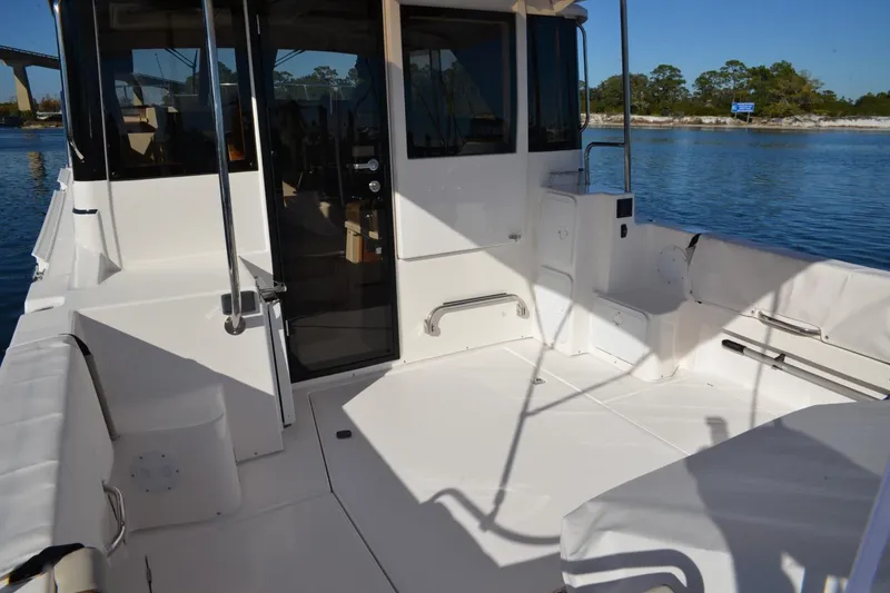 Slide: The Image of 2020 Cutwater C-30S boat deck with seating, docked on calm water. - 4