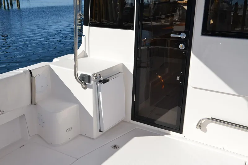 Slide: The Image of 2020 Cutwater C-30S boat deck with glass door and railing by the water. - 5