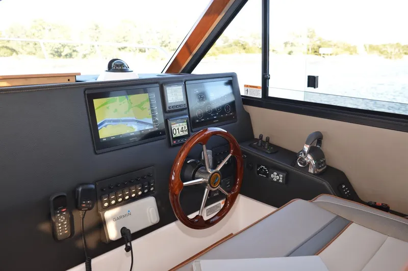 Slide: The Image of 2020 Cutwater C-30S helm with navigation screens, steering wheel, and control panel. - 6