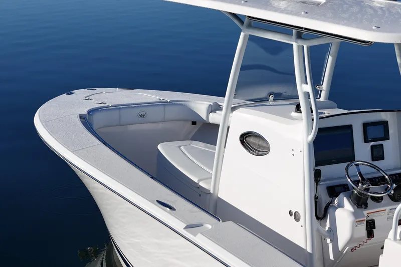 Slide: The Image of 2019 Southport 272 TE boat with sleek design and modern console on calm water. - 11
