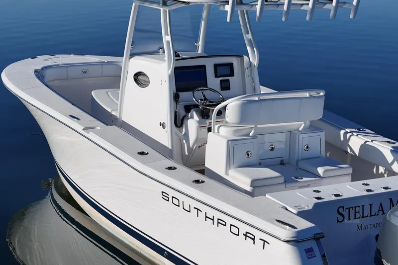 Slide: The Image of 2019 Southport 272 TE boat with sleek design on calm water. - 12