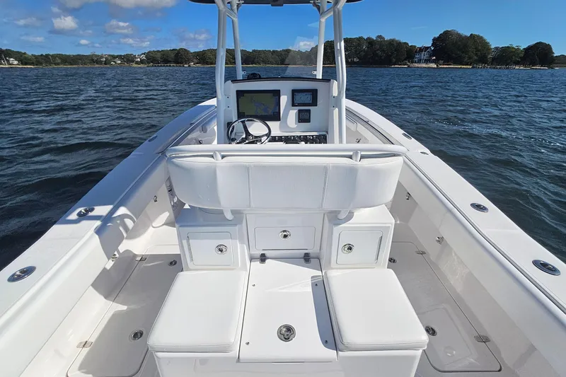 Slide: The Image of 2019 Southport 272 TE boat interior with helm, seating, and open water view. - 18