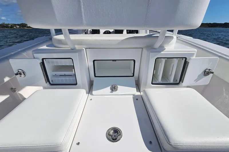 Slide: The Image of 2019 Southport 272 TE boat interior with open storage compartments and seating. - 20