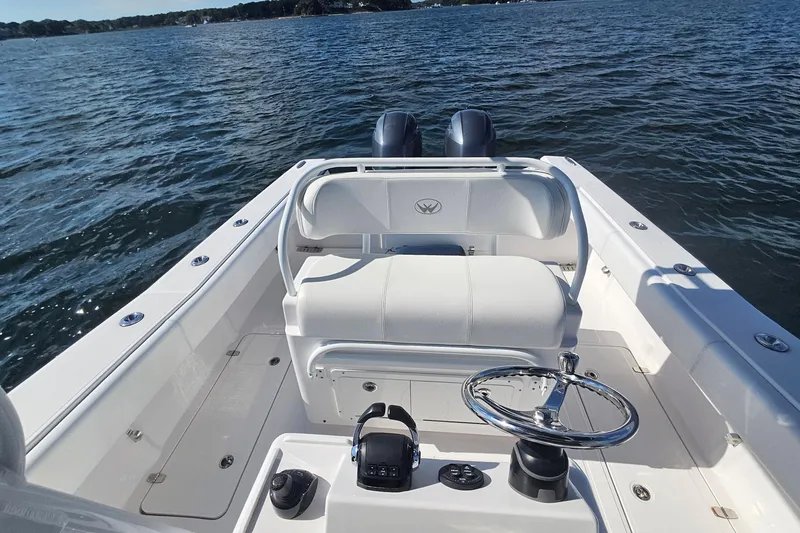Slide: The Image of 2019 Southport 272 TE boat cockpit with steering wheel on open water. - 22