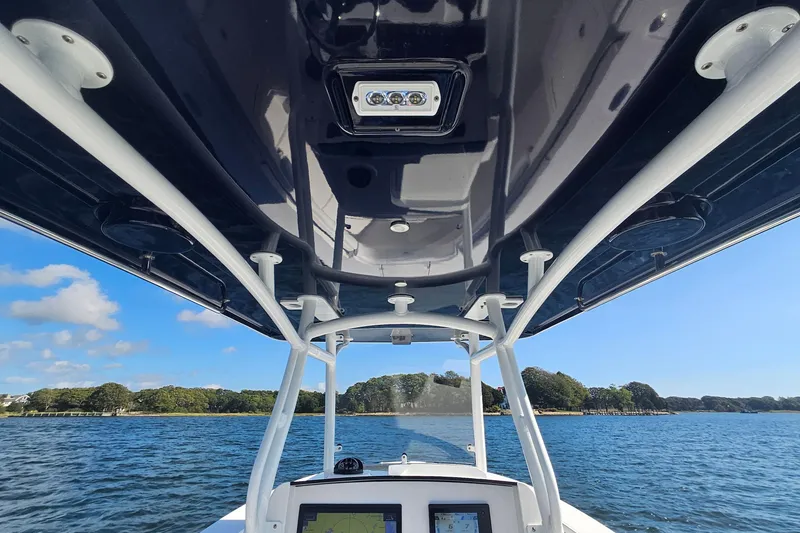 Slide: The Image of 2019 Southport 272 TE boat interior with T-top, navigating on a sunny day. - 25