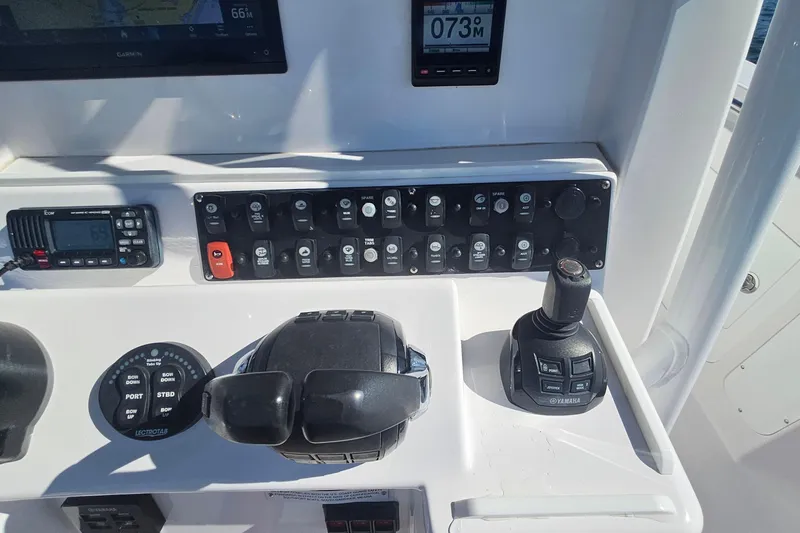 Slide: The Image of Control panel of a 2019 Southport 272 TE boat with navigation and throttle controls. - 27