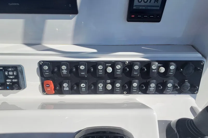 Slide: The Image of Control panel of a 2019 Southport 272 TE boat with various switches and displays. - 28