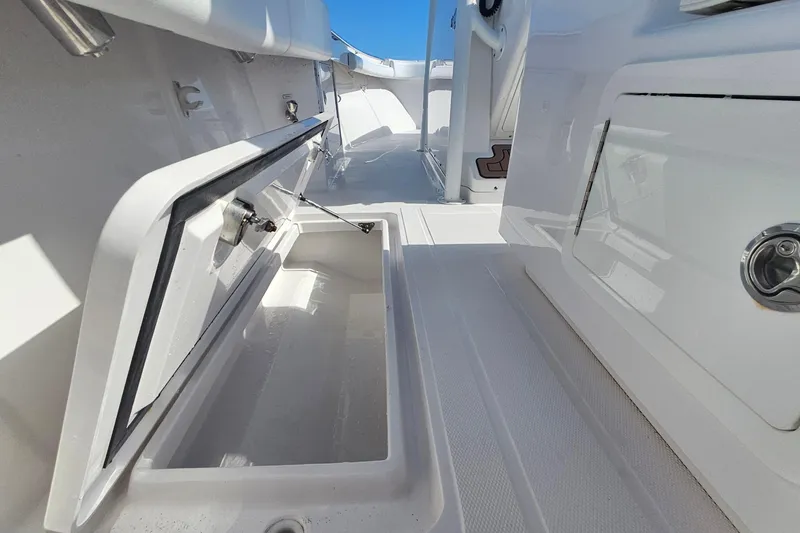 Slide: The Image of 2019 Southport 272 TE boat interior with open storage compartment, white finish. - 34
