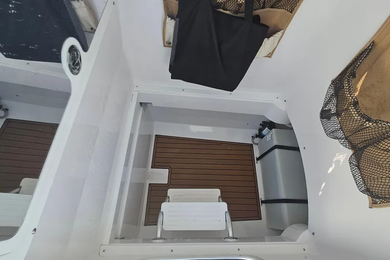 Slide: The Image of 2019 Southport 272 TE boat interior with wooden flooring and storage compartments. - 36