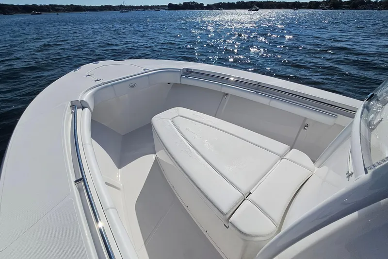 Slide: The Image of 2019 Southport 272 TE boat interior with white seating, on a sunny day at sea. - 37