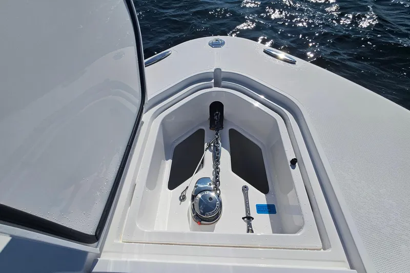 Slide: The Image of 2019 Southport 272 TE boat anchor compartment with chain and winch on open water. - 42