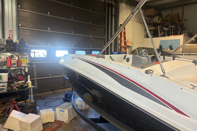 Slide: The Image of 2020 Tahoe T16 boat in garage, surrounded by tools and equipment. - 16