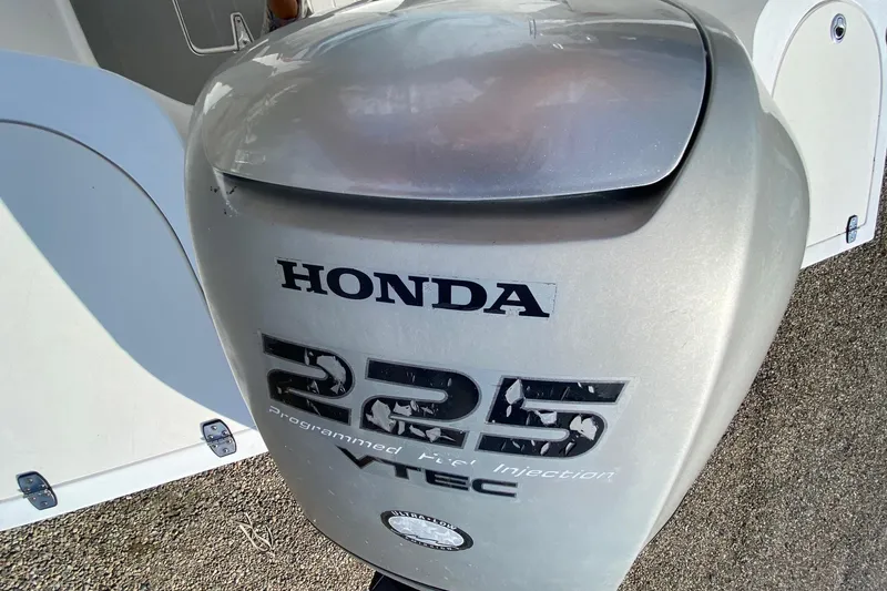 Slide: The Image of Honda 225 VTEC outboard motor on 2002 Mako 221 Center Console boat. - 11