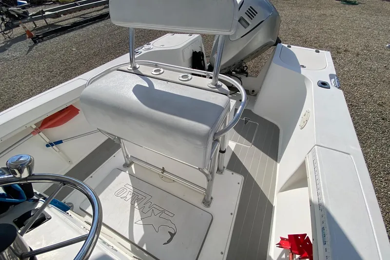 Slide: The Image of 2002 Mako 221 Center Console boat interior with steering wheel and seating. - 15