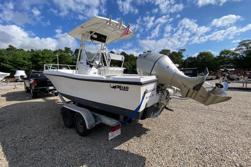 Slide: The Image of 2002 Mako 221 Center Console boat on trailer, parked outdoors under a blue sky. - 3
