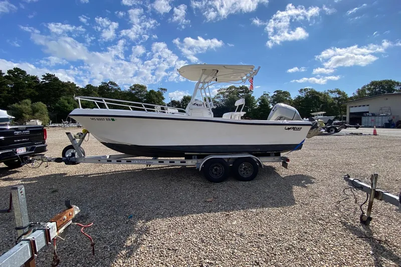 Slide: The Image of 2002 Mako 221 Center Console boat on trailer under clear sky. - 4