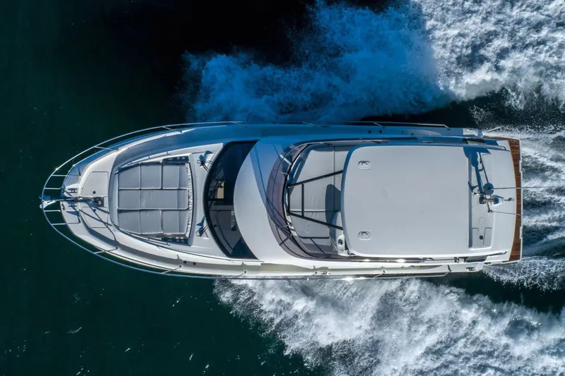 Slide: The Image of 2024 Prestige 460 yacht cruising near rocky cliffs on a sunny day. - 3