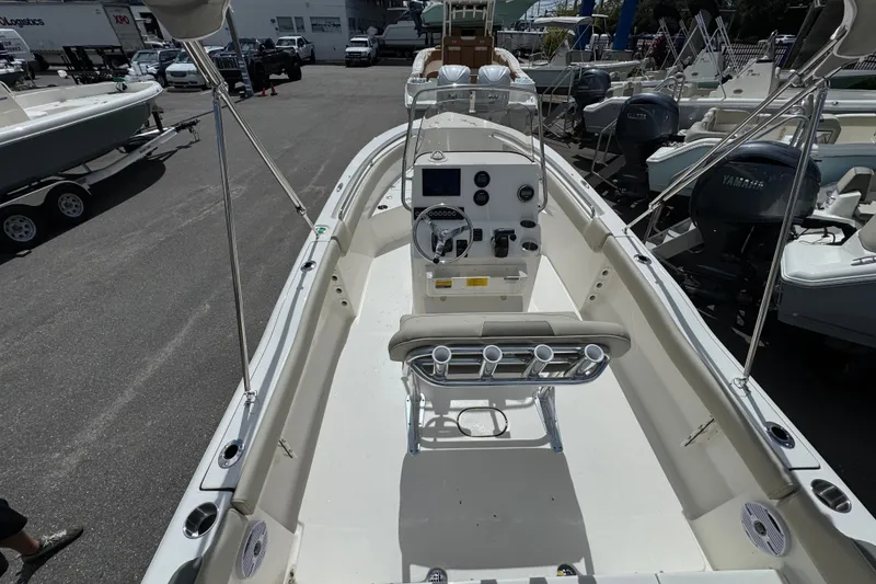 Slide: The Image of 2026 Key West 203 FS boat interior with console and seating, displayed outdoors. - 10