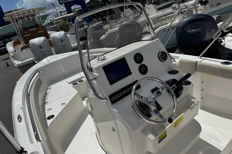 Slide: The Image of 2026 Key West 203 FS boat interior with steering wheel and control panel. - 12