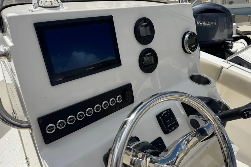 Slide: The Image of 2026 Key West 203 FS boat dashboard with Garmin display and Yamaha controls. - 14