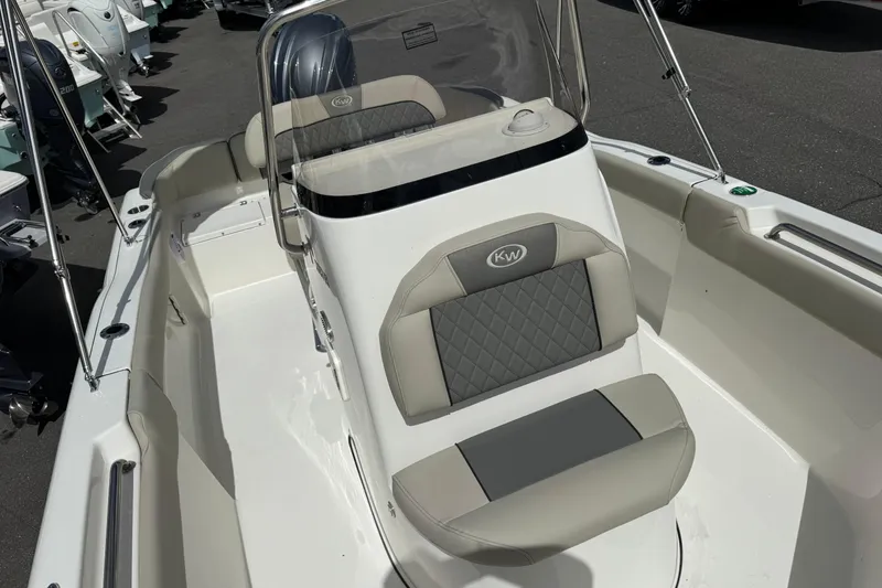 Slide: The Image of 2026 Key West 203 FS boat interior with cushioned seating and windshield. - 19