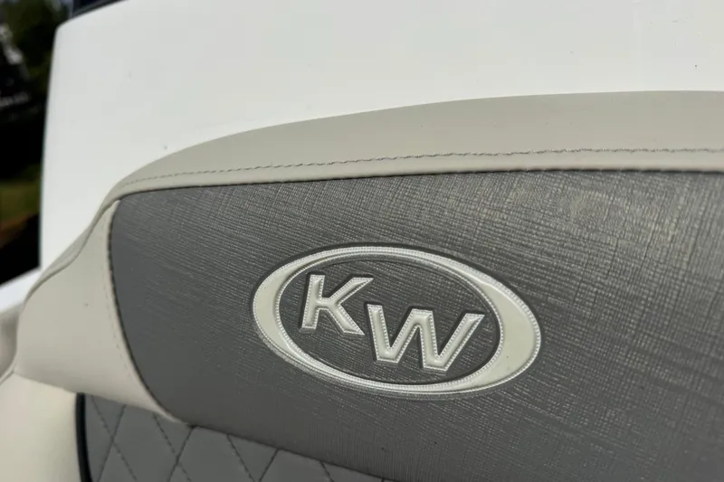 Slide: The Image of 2026 Key West 203 FS boat seat with KW logo, featuring gray and white upholstery. - 21