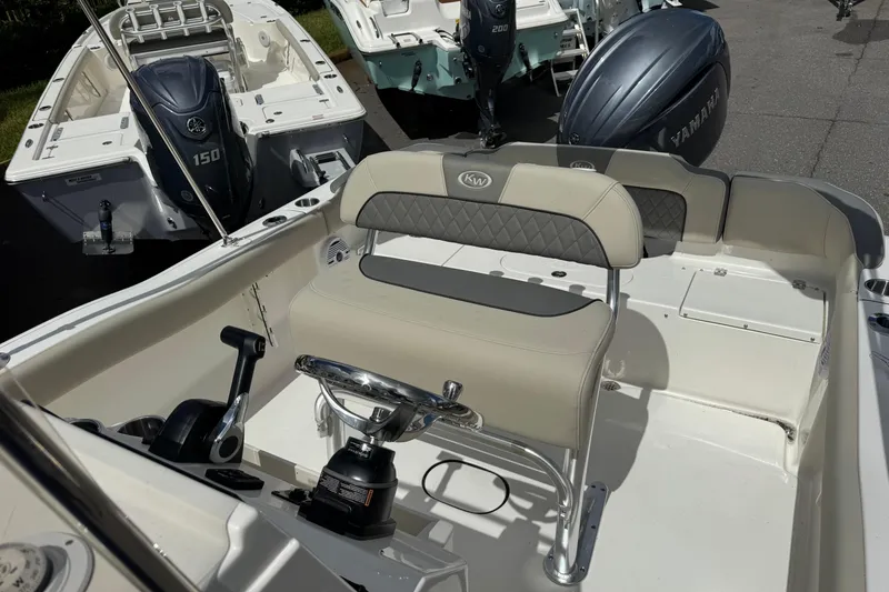 Slide: The Image of 2026 Key West 203 FS boat interior with seating and Yamaha outboard motor. - 22