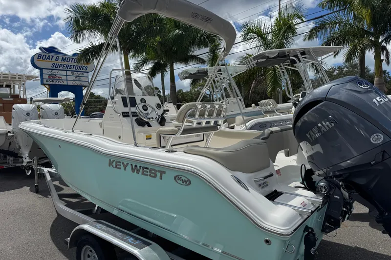 Slide: The Image of 2026 Key West 203 FS boat with Yamaha engine at dealership, surrounded by palm trees. - 3