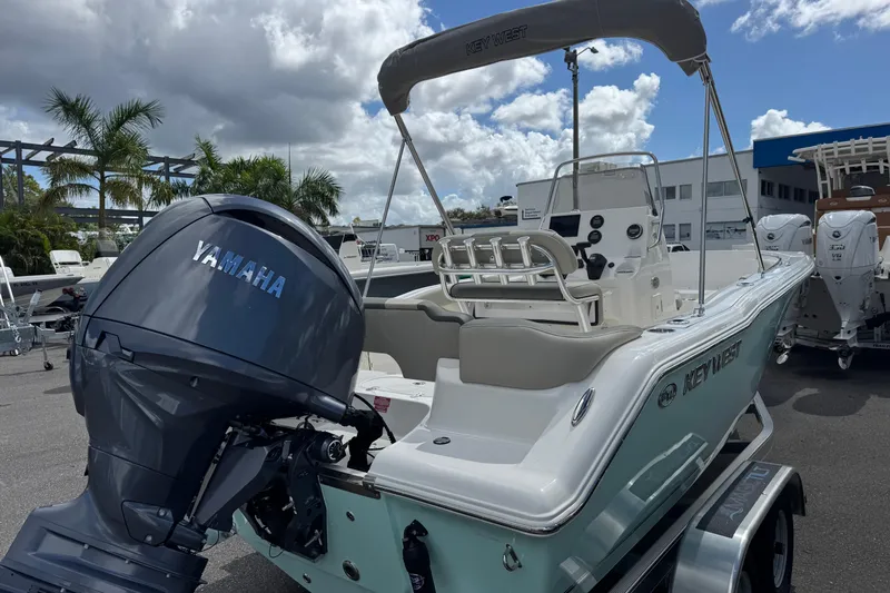 Slide: The Image of 2026 Key West 203 FS boat with Yamaha engine, parked outdoors under cloudy sky. - 5
