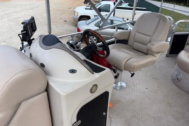 Slide: The Image of 2012 Tahoe Pontoon VT 2285 EL interior with steering wheel and seating. - 11