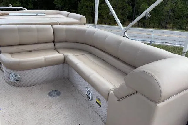 Slide: The Image of 2012 Tahoe Pontoon VT 2285 EL with beige seating, outdoor setting. - 12