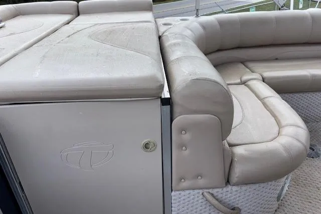 Slide: The Image of 2012 Tahoe Pontoon VT 2285 EL with beige seating and storage compartment. - 16