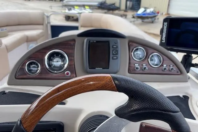 Slide: The Image of 2012 Tahoe Pontoon VT 2285 EL dashboard with steering wheel and navigation system. - 19