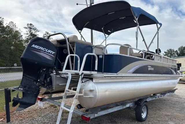 Slide: The Image of 2012 Tahoe Pontoon VT 2285 EL with Mercury outboard engine on trailer. - 2