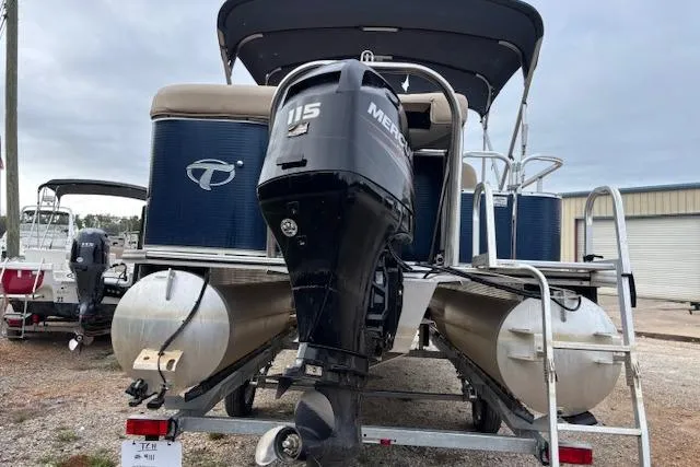 Slide: The Image of 2012 Tahoe Pontoon VT 2285 EL with Mercury 115 outboard motor, docked outdoors. - 24
