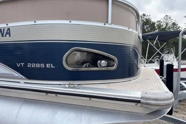 Slide: The Image of 2012 Tahoe Pontoon VT 2285 EL boat, blue and silver exterior, docked outdoors. - 26