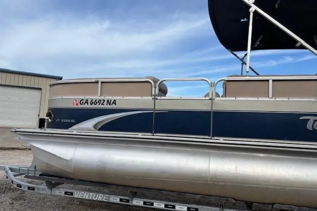 Slide: The Image of 2012 Tahoe Pontoon VT 2285 EL on trailer, side view with registration number visible. - 5