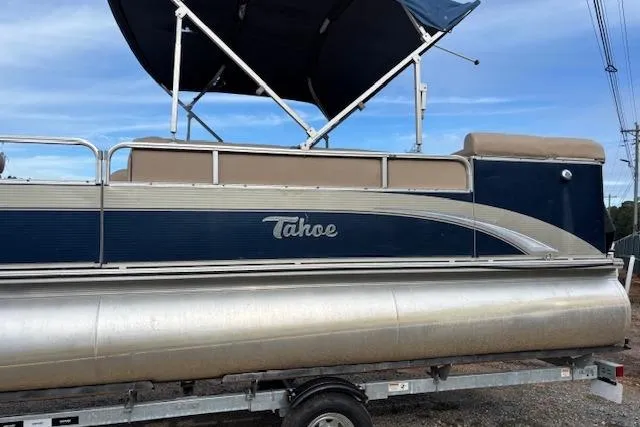 Slide: The Image of 2012 Tahoe Pontoon VT 2285 EL on trailer with blue canopy and beige seating. - 6