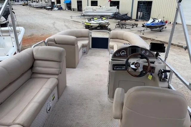 Slide: The Image of 2012 Tahoe Pontoon VT 2285 EL with spacious seating and modern dashboard. - 9