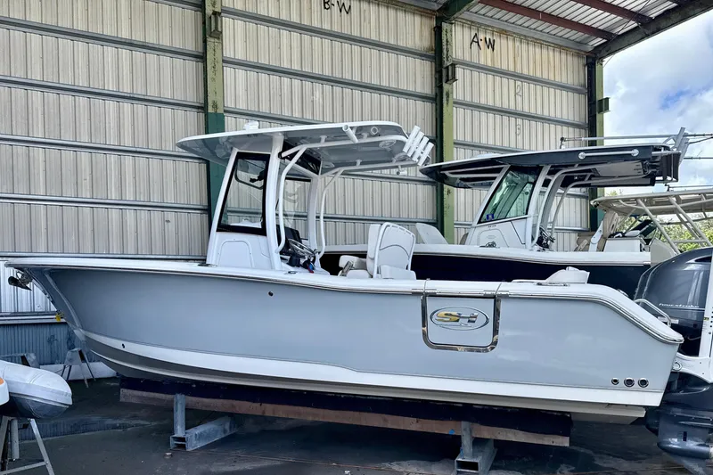 The Image of 2023 Sea Hunt Ultra 265 SE boat in storage, side view. - 0